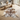 Cowhide rug on a wooden floor with a modern living room setting.