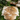 Cowhide rug on grass with outdoor furniture and plants in the background